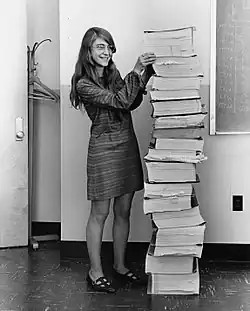 Image 2Margaret Hamilton standing next to the navigation software that she and her MIT team produced for the Apollo Project.