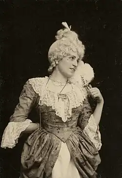 Another black and white photograph of a woman in luxurious eighteenth-century garb, gazing pleadingly above her