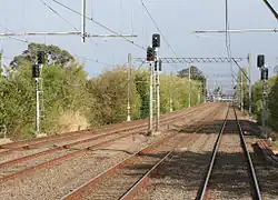 4 tracks heading towards the city with signalling and electrical equipment shown.