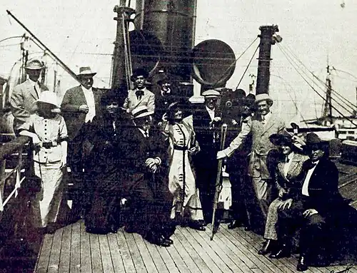Press photo of a group aboard a boat.