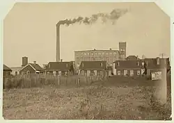 An image capturing the housing conditions for iron mill workers during the industrial era.