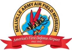 Anthropomorphic bee with red wings holding two bombs, inside a yellow circle reding "Millville Army Airfield museum, above a red banner reading "America's First Defense Airport: 1941-1945"