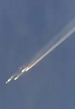 Picture of debris burning up backdropped against the sky