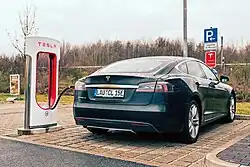 A blue Model S charging at a Supercharger