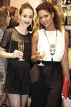 Image 99Two women in Brazil wearing monochromatic evening outfits with sheer elements and streamlined silhouettes, 2014. (from 2010s in fashion)