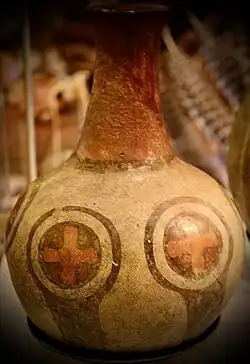 Oblong emblem with an embedded cross-in-circle motif