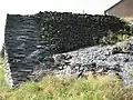 Detail of an old slate quarry wall in Rimogne.