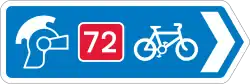 Blue traffic sign with a Roman helmet icon, a white bicycle symbol and a red square with the number 72 in it.