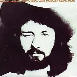 Black and white headshot of Michael Nesmith wearing a white cowboy hat and winking, with his name and the album title in orange letters across the top.