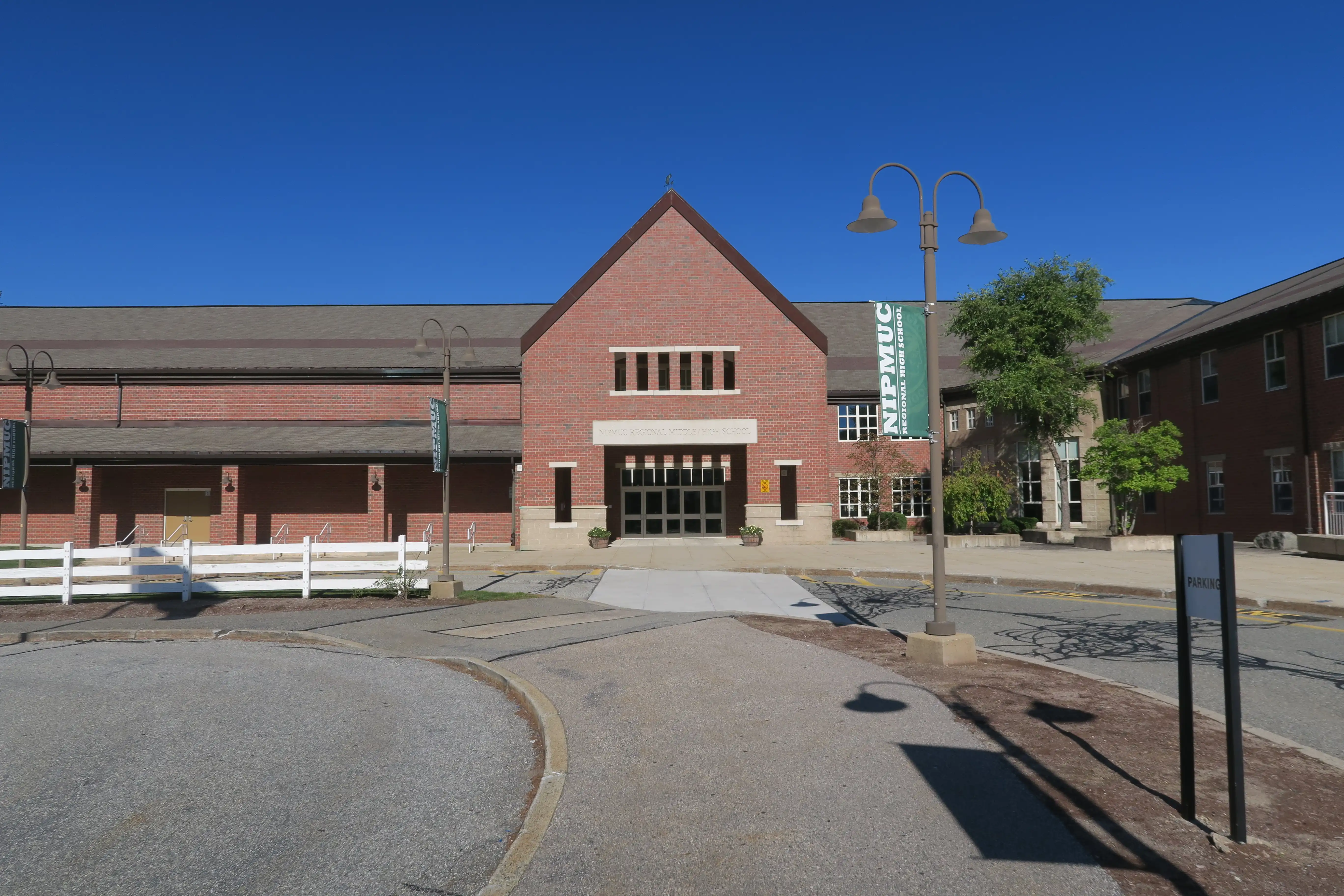 A photo of the front entrance and architecture of the school, taken during the daytime.