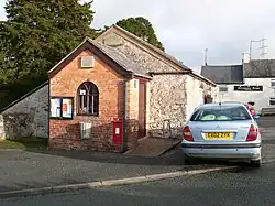 White brick 18th-century building with some later additions.