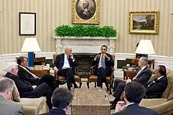 Barack Obama (right) and Joe Biden (left) hold a meeting beneath the prominently visible ivy alongside other US leaders, including John Boehner and Harry Reid.