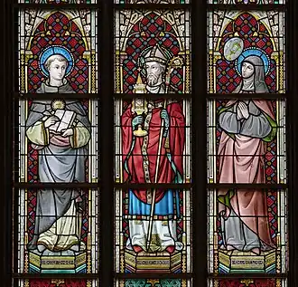 Stained glass at Église Saint-Jacques de Tournai depicting Saints Thomas Aquinas, Norbert von Xanten and Juliana Falconieri