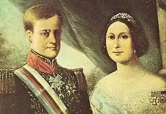 A side-by-side portrait with a light-haired, clean-shaven young man in a military-style tunic on the left, and on the right, a young woman with dark hair decorated with a tiara