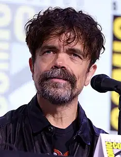 Dinklage speaking into a microphone