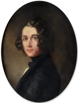 A man with shoulder-length black hair