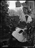 Portrait of girl with grapes. 1912.