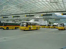 A fleet of Neoplan Transliners in the Swiss "Postautos" colours