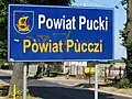 Bilingual sign in Polish and Kashubian in Pogórze, Puck County, Poland, on road from Gdynia to Rewa