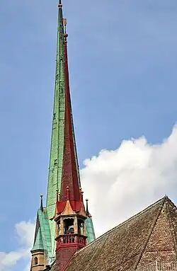 The 27.1 metres (88.9 ft) high ridge turret of Predigerkirche Zürich, its 96 metres (315 ft) clock tower in the background.