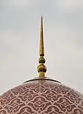 The patterned dome of pink and white granite tiles is a distinctive feature.