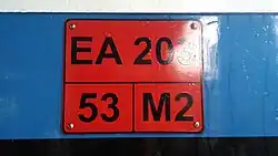 Plate on the EA203 series stating the EMU facility class number (not the service class type), maximum weight, and train code