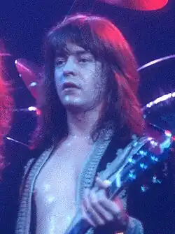 Derringer playing guitar onstage