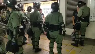 Several riot police officers checked young people at Hung Hom station.