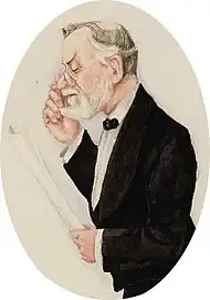 white man in late middle age with thinning white hair and a neat moustache and beard