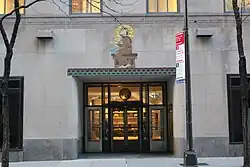 Saint Francis of Assisi decoration over the entrance at 9 West 50th Street