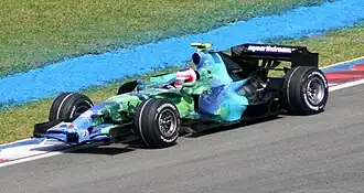 The 2007 Honda RA107 in its distinctive Earth livery, being driven by Rubens Barrichello at Malaysia in 2007.