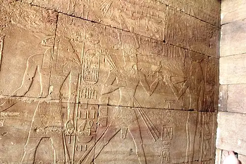 Temple of Kumma: The ram-headed Khnum (left) and Tuthmosis III (center) running towards Hathor (right) offering her a lapwing