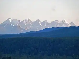 Seven mountains lined up neatly in a row in the far distance
