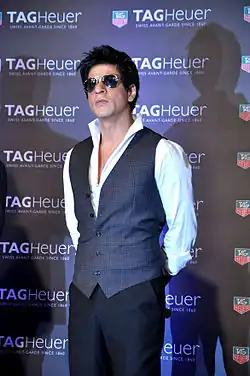 Shah Rukh Khan wearing sunglasses and a vest at a promotional event