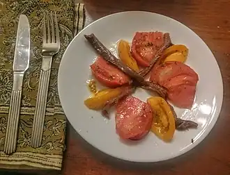 A simple salad of anchovies and tomato wedges