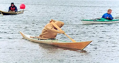 A kayaker in a tuiliusaq, in the starting position for a siukkut tunusummillugu roll