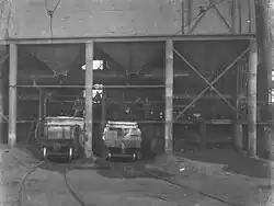 Great Cobar mine, slag runoff into ladle wagons (1912). The flue dust collection hoppers are visible below the brickwork.