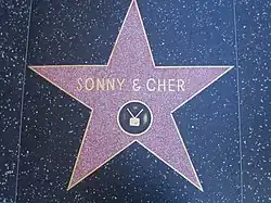 A star on the Hollywood Walk of Fame, featuring a TV emblem in the center, honors the duo Sonny & Cher.