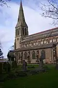 St Bartholomew's Church, Roby, Lancashire, 1875 by Ewan Christian, solidly built in rock-faced stone with ashlar dressings. The church has an impressive west steeple with a broach spire and has a prominent clerestory and an apsed chancel[164]