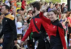 People wearing Star Trek: the Next Generation uniforms in a parade.