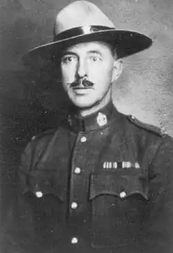 A young man with a moustache, wearing a police serge and stetson hat
