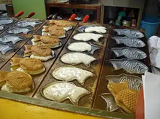 Taiyaki cakes being made in the shape of red seabream (tai)