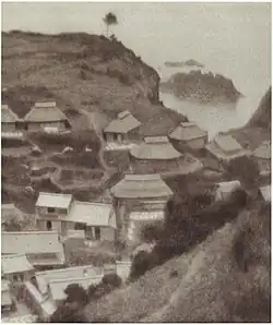 Photograph of the village of Okidomari, extensively retouched to blur detail