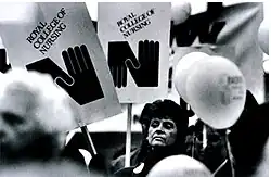 Assembly of nurses, carrying placards with the Royal College of Nursing identity, designed by David Hillman