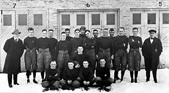 Black and white photo of the 1919 Packers team standing in front of a building