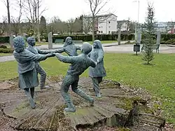 'The Dream' sculpture with Glenrothes war memorial in backdrop