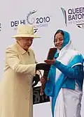 Elizabeth II passing the Baton to President Pratibha Patil of India for the Queen's Baton Relay for the Delhi 2010 Commonwealth Games