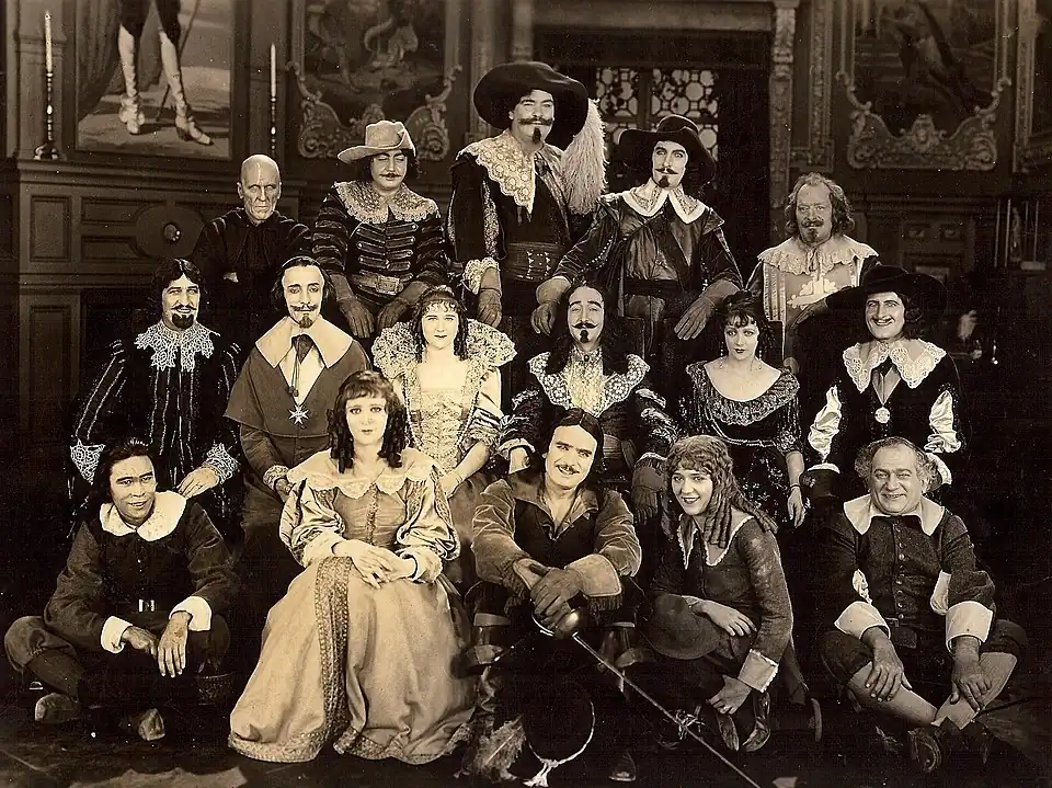Front row: Charles Stevens, Marguerite De La Motte, Douglas Fairbanks, Mary Pickford (guest), Sidney Franklin. Second row: Boyd Irwin, Nigel De Brulier, Mary MacLaren, Adolphe Menjou, Barbara La Marr, Thomas Holding. Back row: Lon Poff, Eugene Pallette, George Siegmann, Léon Bary, Willis Robards.