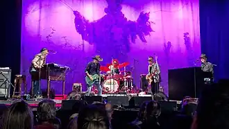 The Waterboys performing at Rock Zottegem in 2023. L–R: "Brother" Paul Brown, Mike Scott, Eamon Ferris, Aongus Ralston and James Hallawell