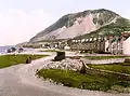 Colourised Photochrom print (circa the late 19th century) of seafront and Penmaenmawr mountain